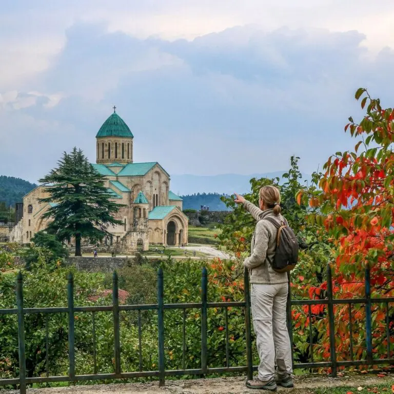 woman pointing at Bagrati Cathedral in Kutaisi, Georgia