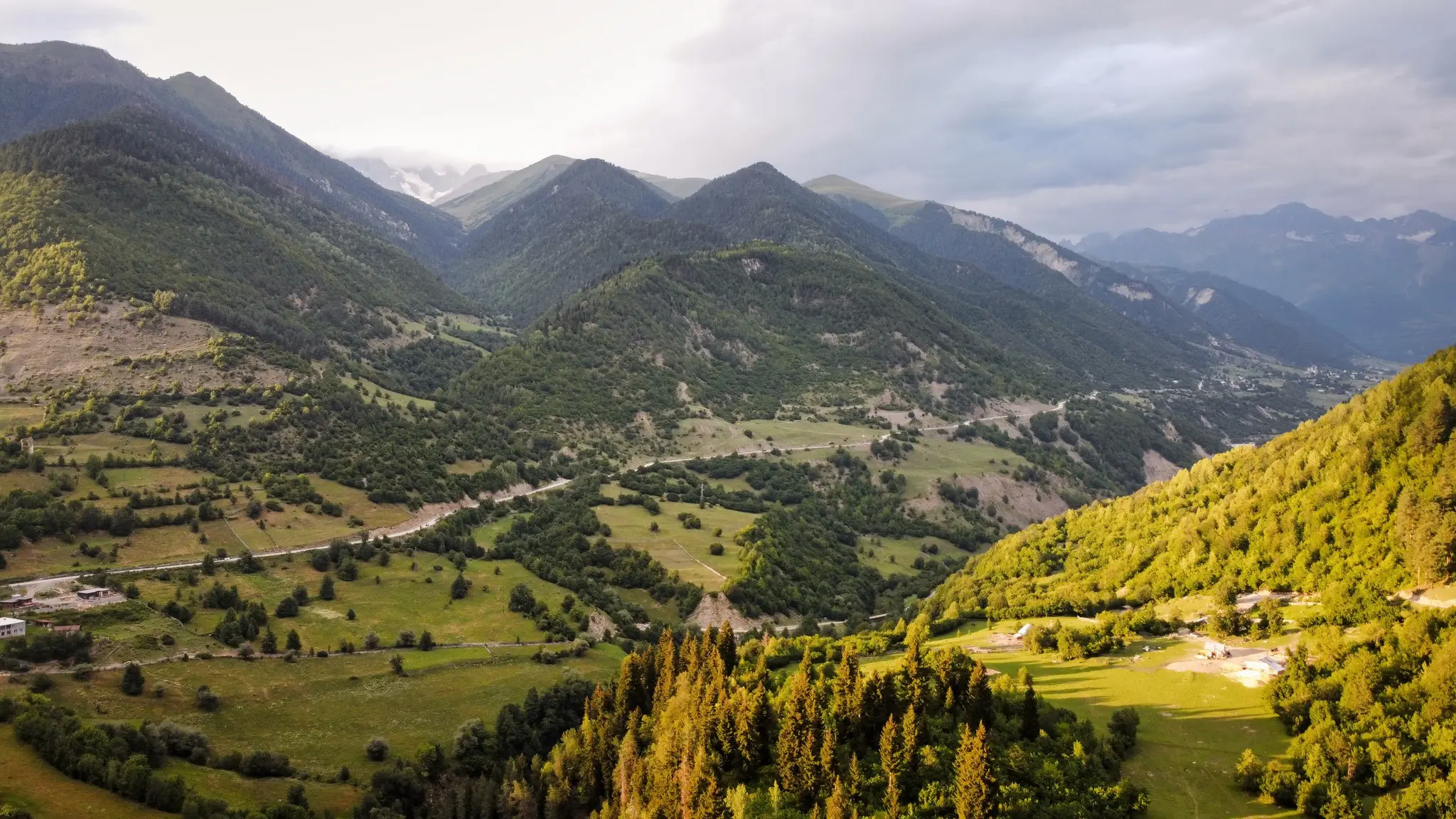 aerial drone view of green mountains and valley in Georgia at sunset